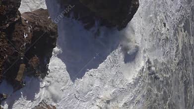 High waves breaking on the rocks of the coastline