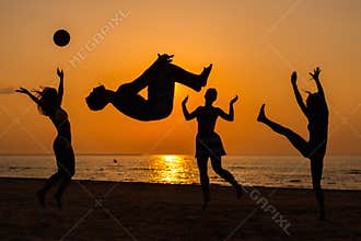 Silhouettes of a people having fun on a beach