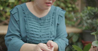 Person with blindness disability learning about soil and growing media for planting and gardening in home garden nature background