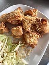 Crispy fried squid pieces with garlic crumb topping served with shredded cabbage salad