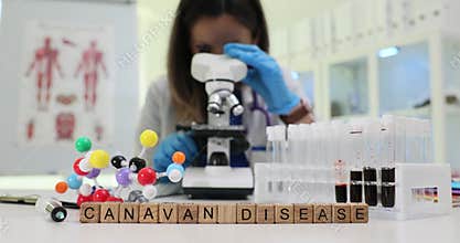 Wooden blocks show Canavan Disease near microscope in lab