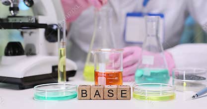 Lab worker observes beaker filled with bright yellow liquid