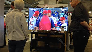 Couple looking for new TV in electronics store