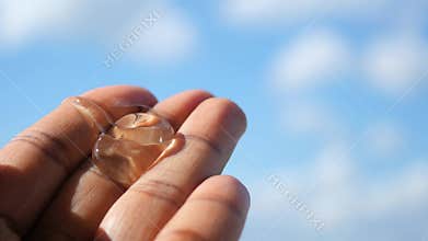 aloe vera jel on hand under blue sky