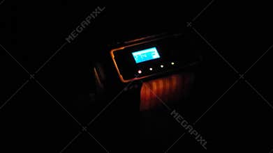 In the dark, the intelligent pulse repair charger works at home to charge the battery