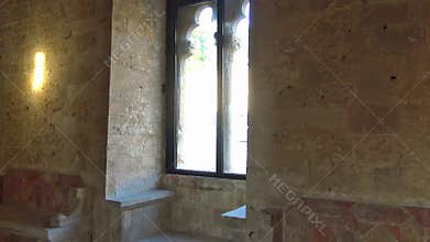 4K medieval castle interior with arched window and stone walls inside historic fortress hall