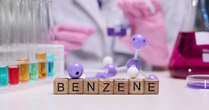 Laboratory technician examines gas purple liquid inside beaker