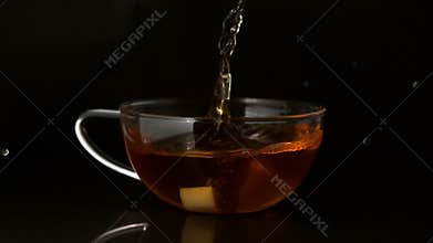 Sugar cube falling into cup of tea