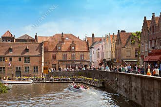 The boat with tourists on river in Brugge