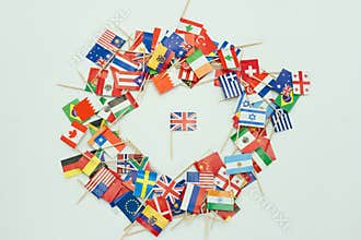 Various country flags arranged in a heart shape with a central focus on the British flag
