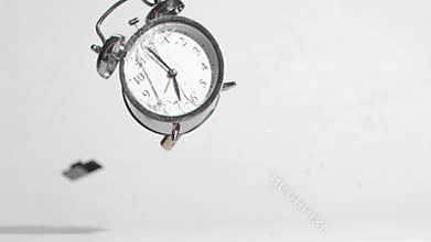 Alarm clock sounds in a super slow motion crushing by a hammer
