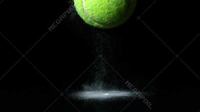 Tennis ball falling on black background