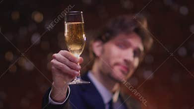 Man hold flute glass of champagne. Celebrates success, victory or winnings, wishes you happy New Year or Christmas. Cheers
