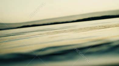 Water surface with ripples reflecting warm light