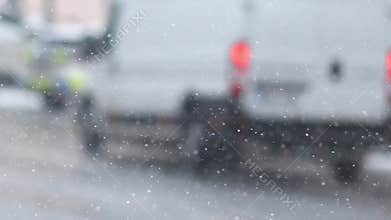 Details of actual snow falling at daytime in European city complicated life