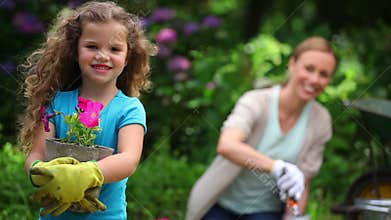 Mother and daughter planting flowers