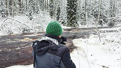 a photographer with a camera on a tripod takes photos, Lindulovskaya grove, an ecological trail, a calm winding river in