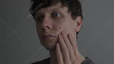 Acne and skin problem. Close up of man touching pimple on face, male skincare, dermatology concept, real life lifestyle.