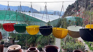 Colorful Hanging Plastic Flower Pots At Outdoor Garden Center