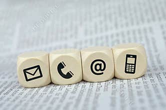 Contact us cubes on a newspaper