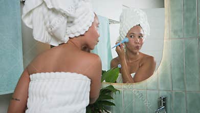 Radiant Black Woman Applies Skincare During Her Morning Routine in a Modern Bathroom