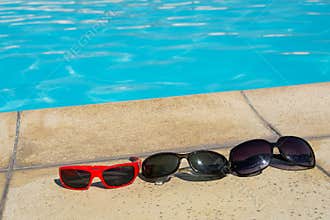 Sunglasses on pool edge