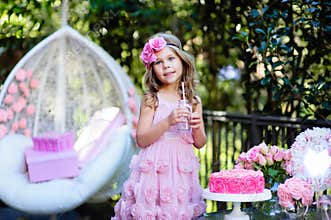 Little girl celebrate Happy Birthday Party with rose outdoor