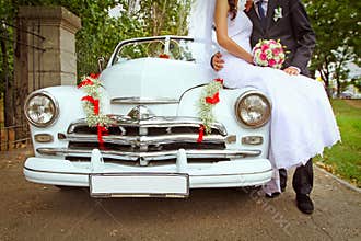Wedding couple with wedding car