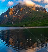 Remarkable sunrise moment with mountain reflection in alpine lake in Caucasus, Georgia
