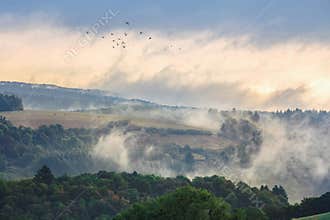 Early morning foggy hills landscape in the country side