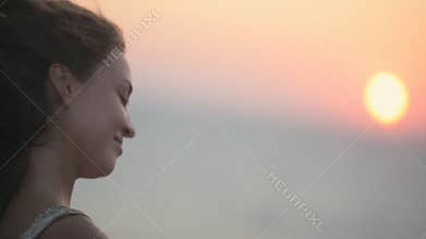 Sad happy girl looking at sunset