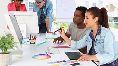 Creative partners working together happily looking at screen