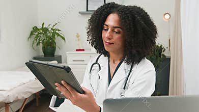 Diverse Doctor Professionalism: Woman Physician Utilizes Tablet for Medical Data in Office Setting
