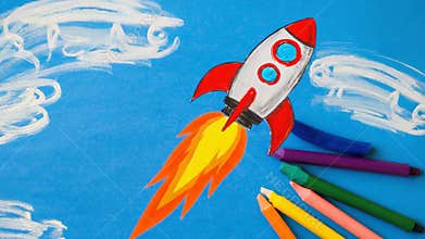 Child\'s crayon drawing of a powerful rocket launching