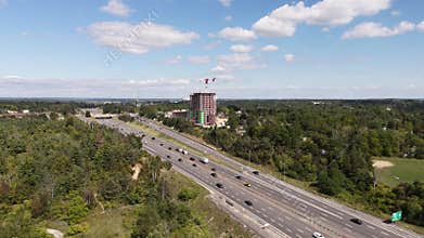 Aerial shot capturing fast-moving traffic on an expansive freeway under a clear sky