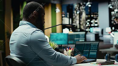 Black consultant reviewing data insights and managing agenda on laptop