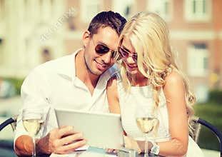 Couple looking at tablet pc in cafe