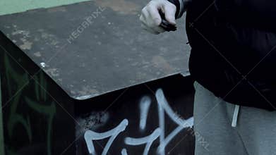 A robber or bandit on the street opens a knife and threatens to use a standard or robbery