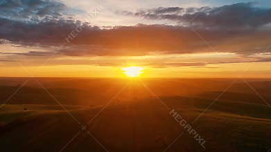 Golden Sunset Over Expansive Rolling Hills and Wide Open Horizon at Dusk