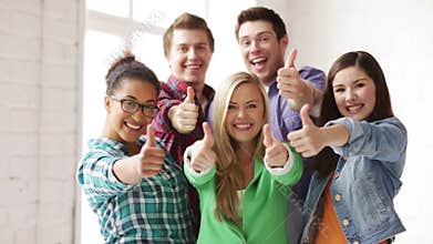 Students in school showing thumbs up