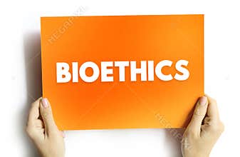 BIOETHICS text on card held by hands, concept of ethics, biology, medicine, research, and human values in science