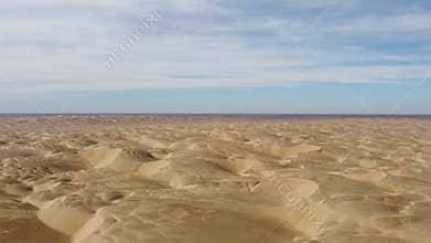desert under cloudy blue sky in xinjiang, china