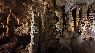 Impressive stalactite and stalagmite formations inside the caves of Postojna, Slovenia.