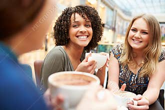 Group Of Young Female Friends Meeting In Cafe