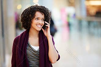 Woman In Shopping Mall Using Mobile Phone