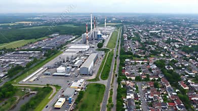 Aerial cityscape over industrial zone with expansive suburban housing and