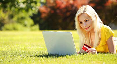 On-line Shopping. Smiling Blonde Girl with Laptop, Credit Card