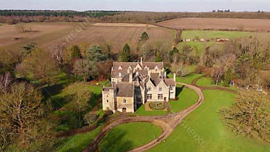 Aerial view of old manor house, stately home with Victorian era architecture and large green landscape