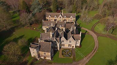 Aerial view of old manor house, stately home with Victorian era architecture and large green landscape