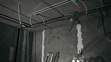Building Renovation With Electrical Installations, Construction Site With Exposed Wiring And Workers